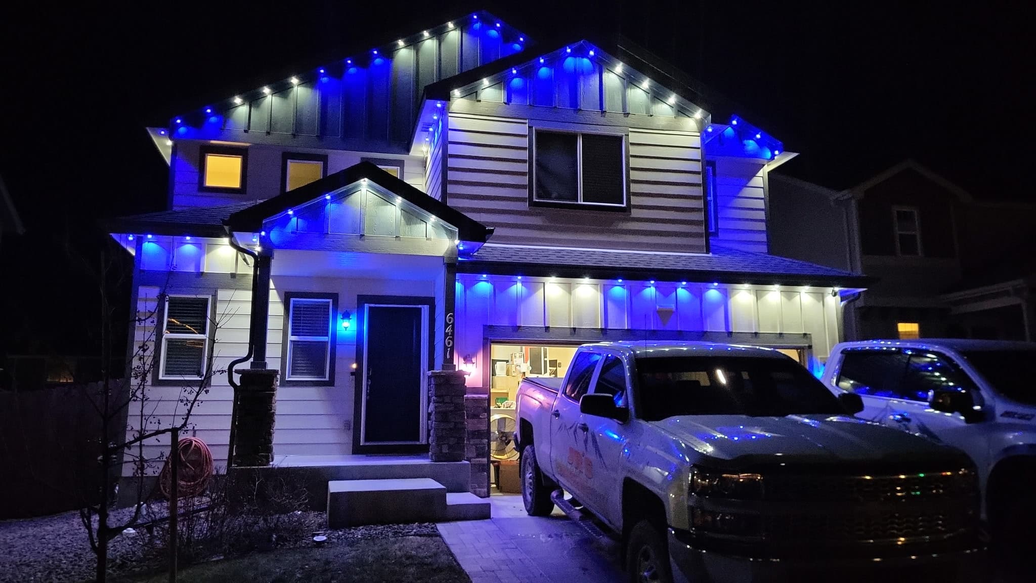 Home decorated with professional Christmas lights at night