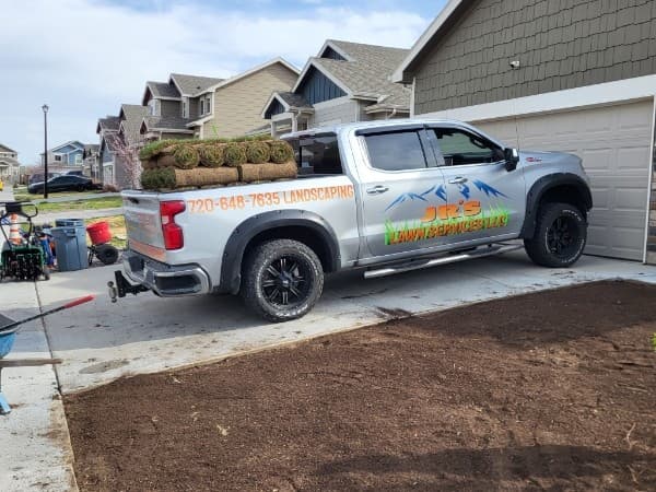 Walk-behind lawn aerator on a residential job site