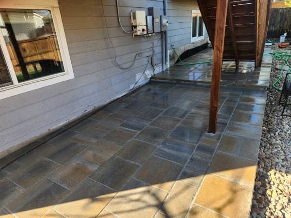 Stone paver patio along a home exterior