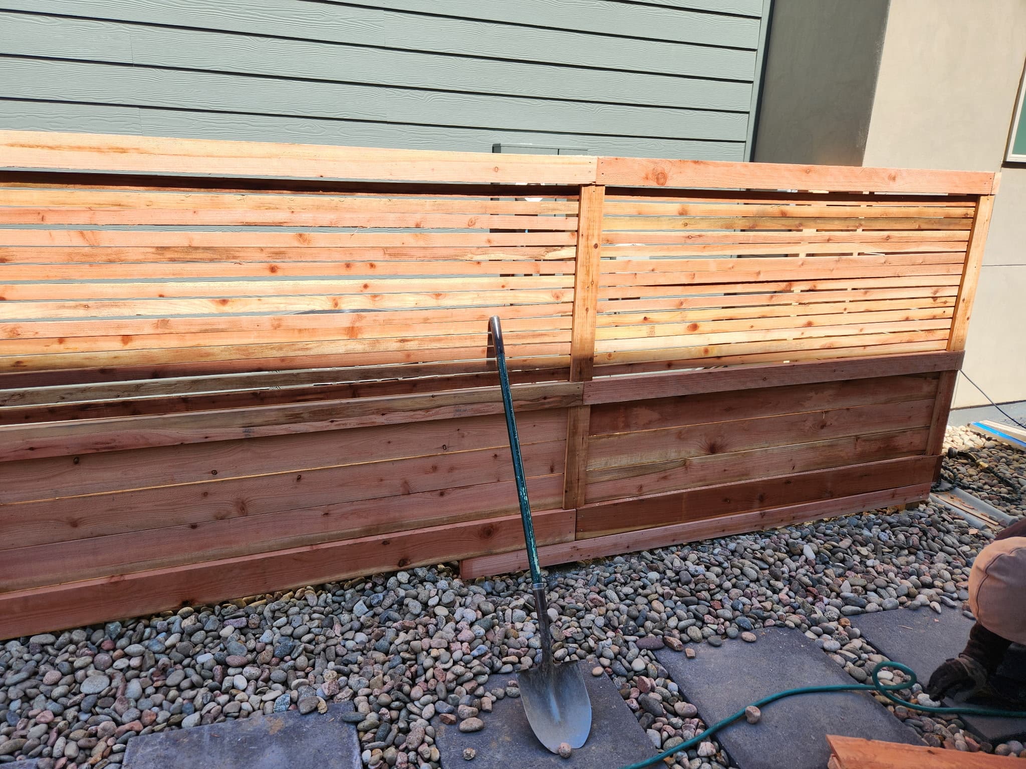 Wood privacy fence along a landscaped yard