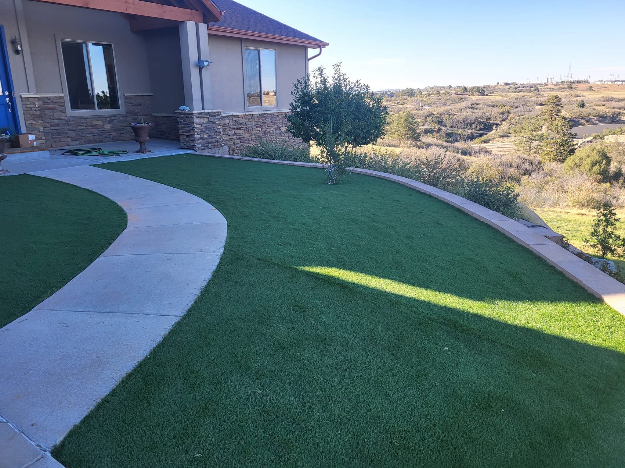 Wide view of a landscaped residential lawn and home exterior